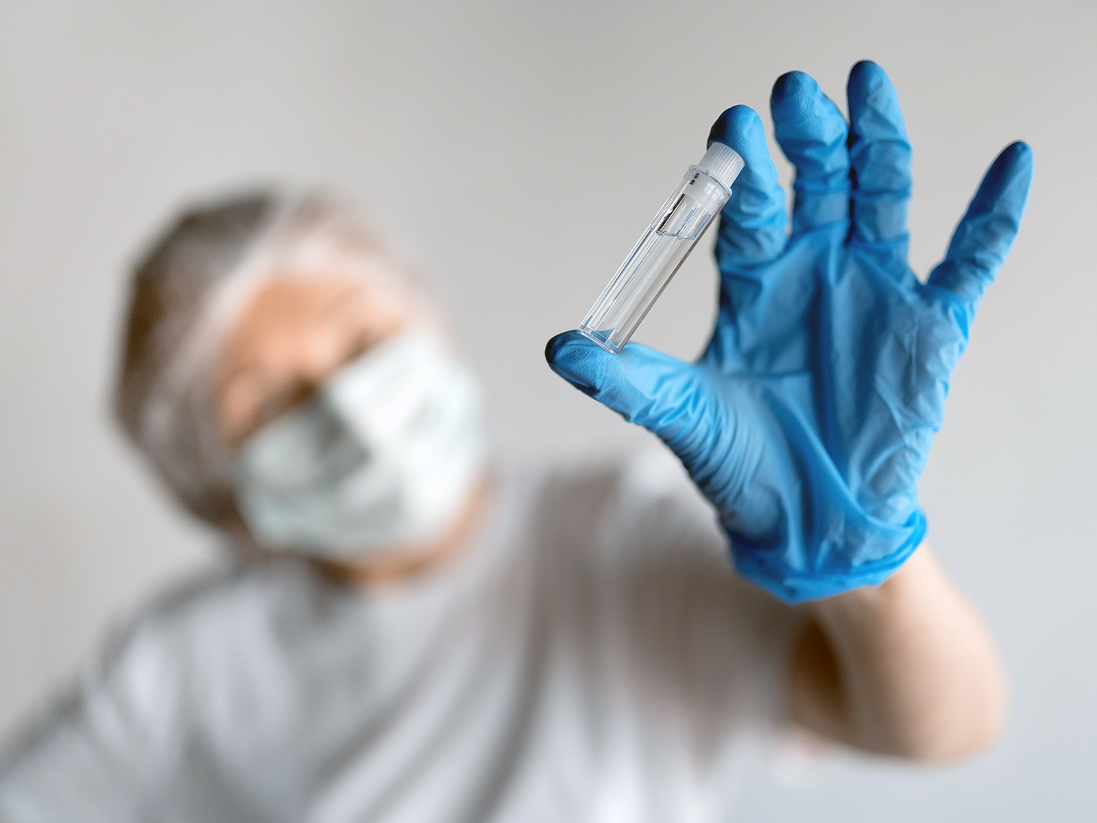 Nurse holding a vial of specialty mediation for infusion or injection